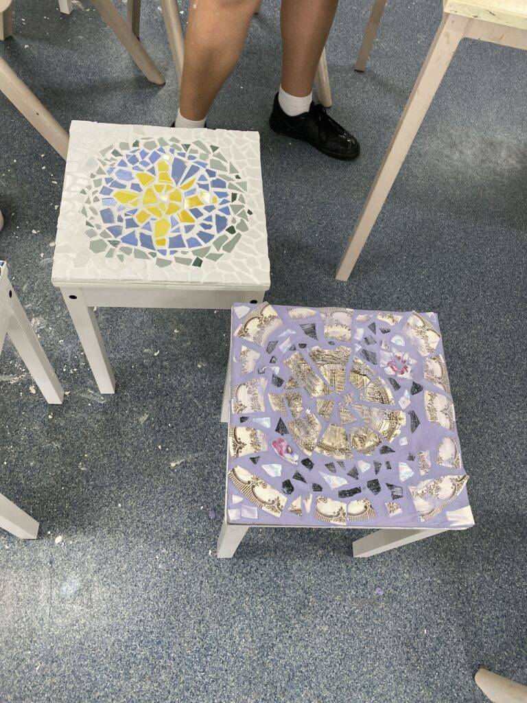 Yr 10s recycling broken ceramic plats to mosaic a table